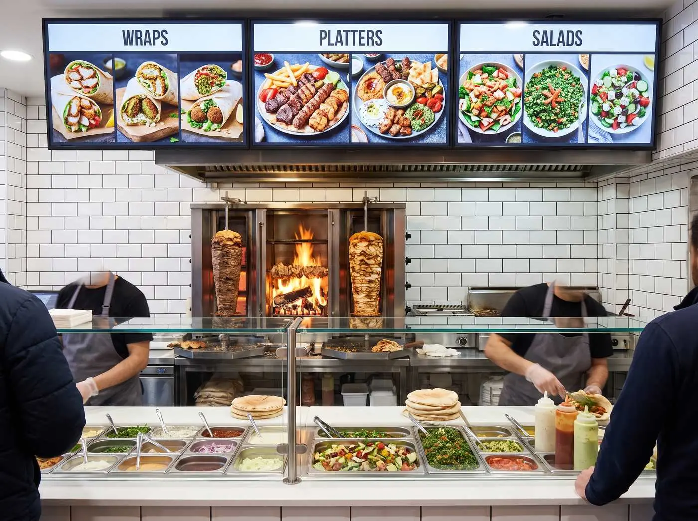 Digital menu board at a Mediterranean grill counter